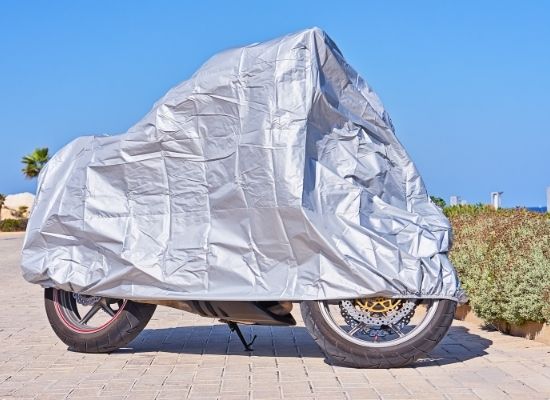 Motorcycle covered with a gray UV protected Cover